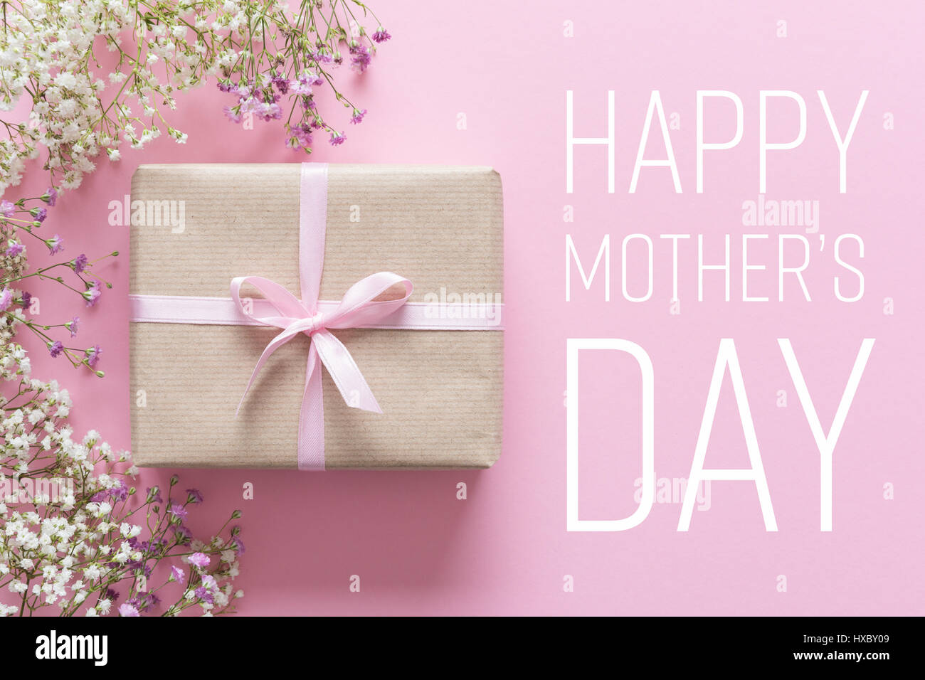 Mother's day card, pink background with white flowers and a present Stock Photo
