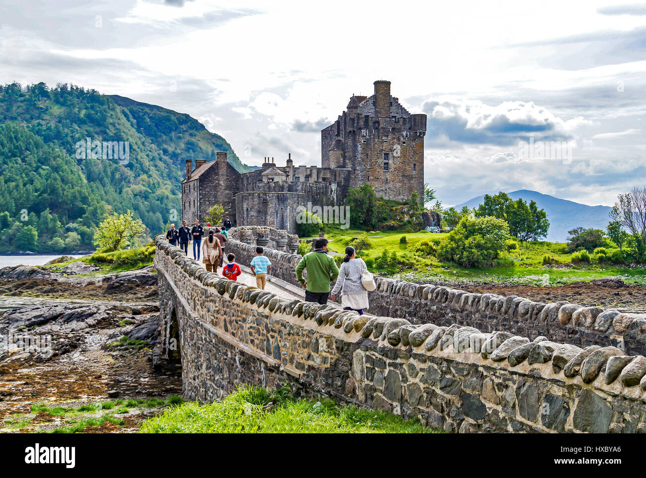 Tourists entering Eilean Donan Castle in at Loch Duich  Dornie Highland Scotland UK Stock Photo