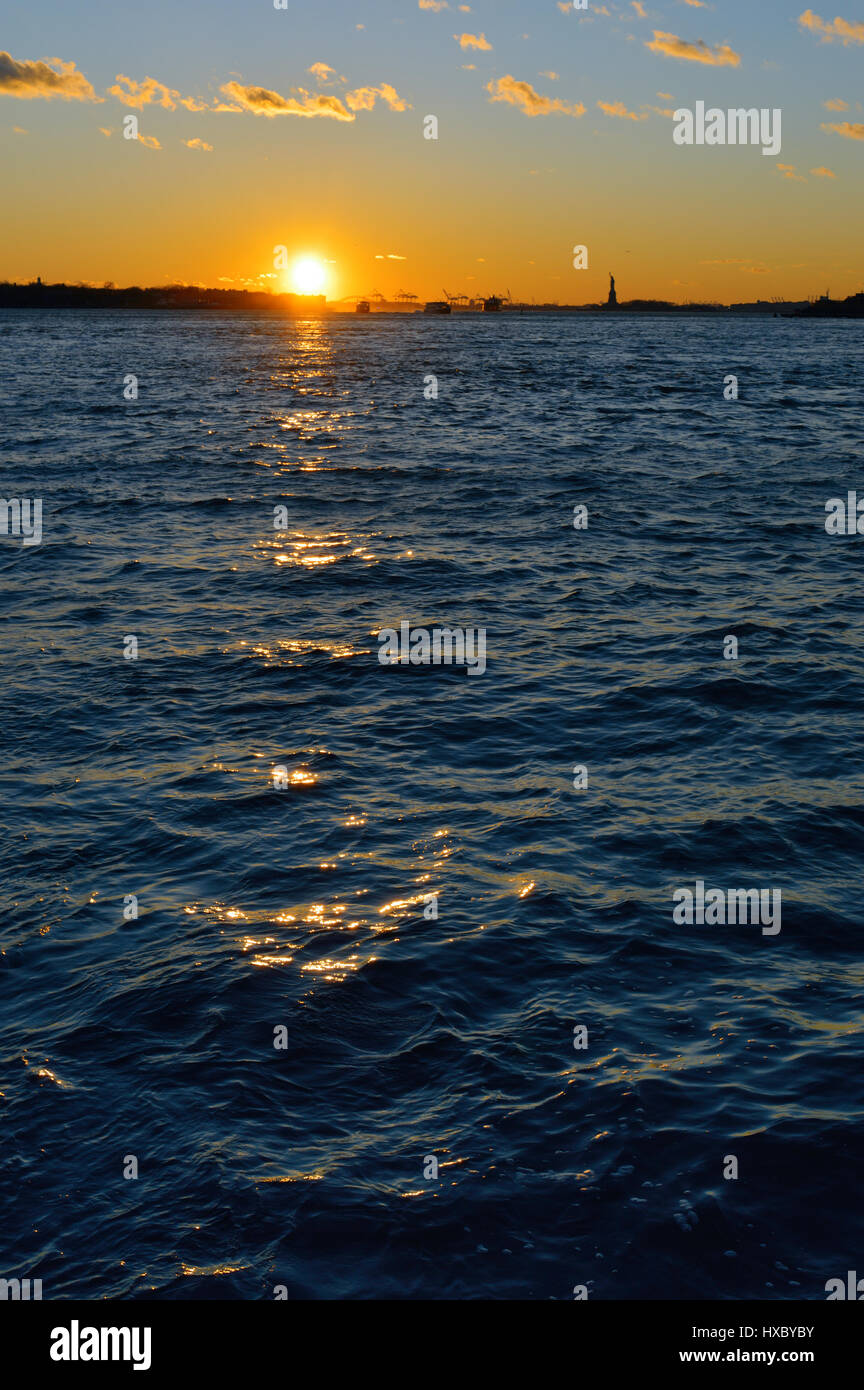 Sunset over a water Stock Photo - Alamy