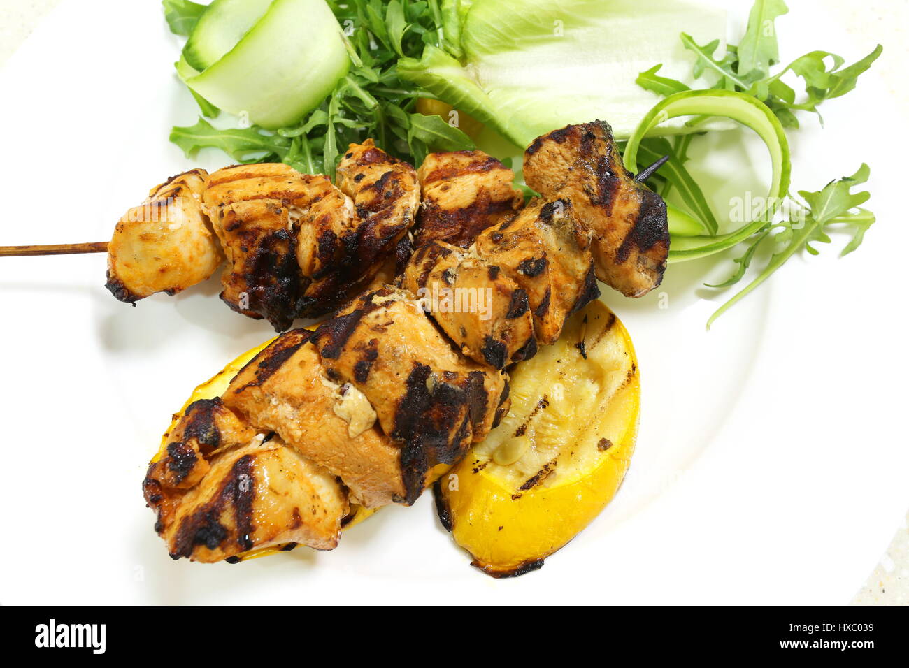 Chicken kebabs served with salad from above Stock Photo