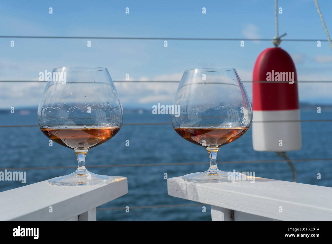 Nautical theme brandy snifter glasses on deck Stock Photo