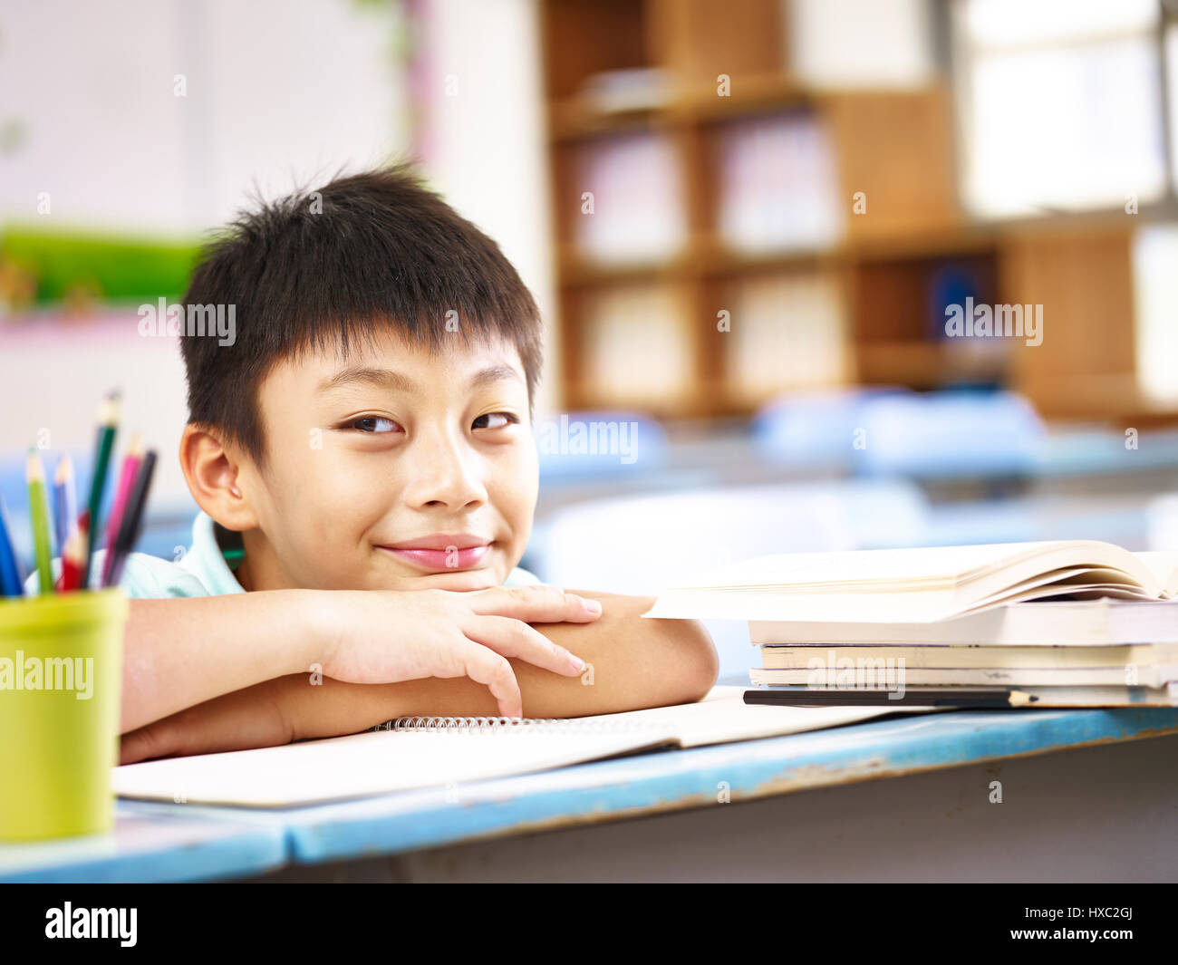 asian elementary school boy showing a funny and naughty face. Stock Photo