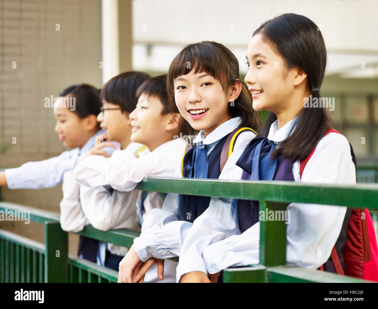asian elementary school girl looking at camera smiling confidently. Stock Photo