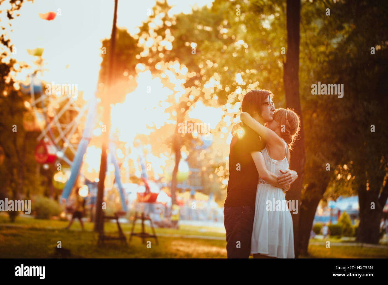 guy and the girl hugging at amusement background Stock Photo - Alamy