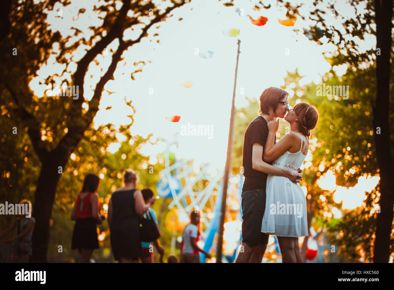 guy and the girl hugging at amusement background Stock Photo - Alamy