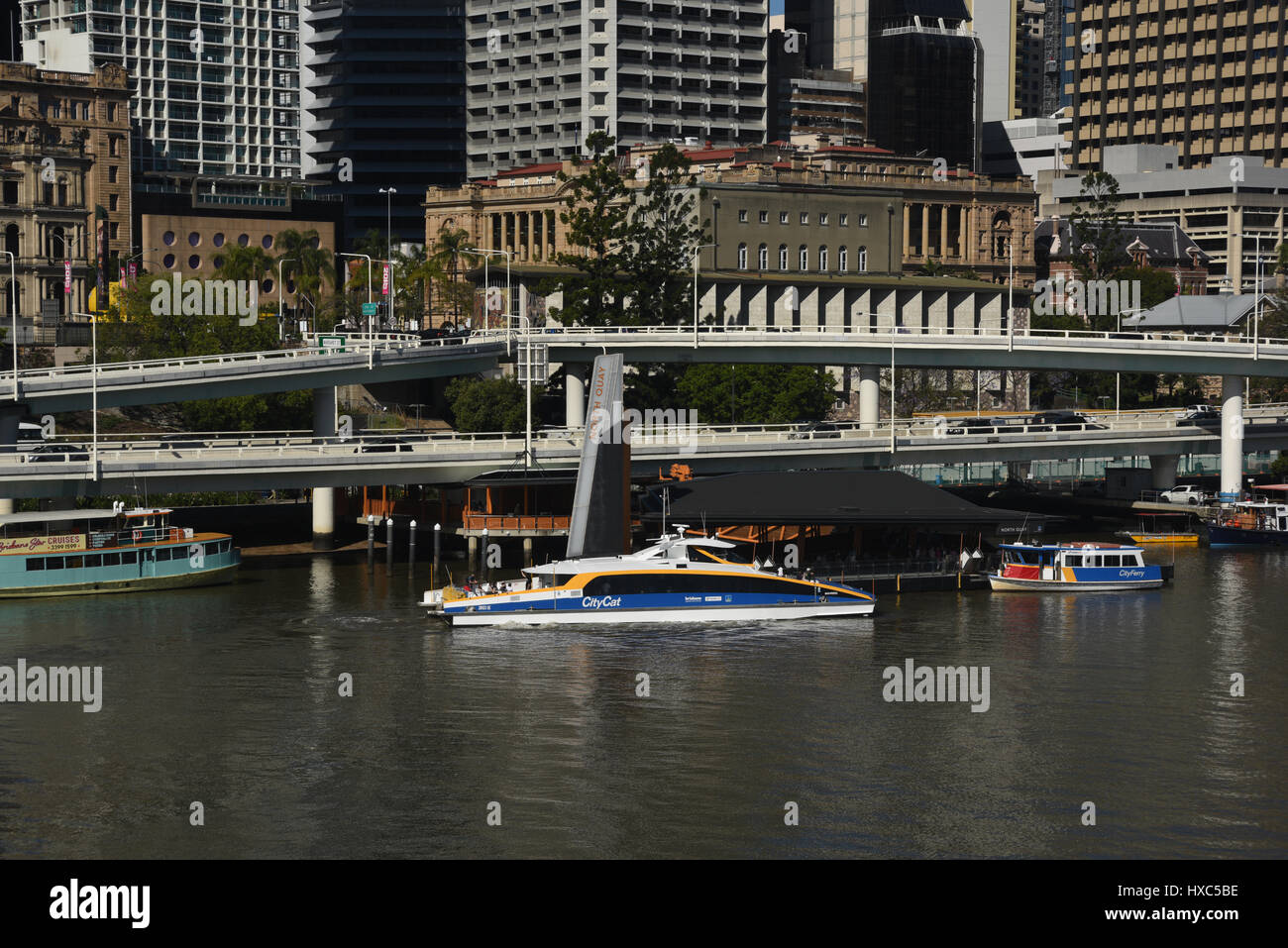 Brisbane, Australia: A CityCat public transport ferry passing the Riverside Expressway on the Brisbane River Stock Photo