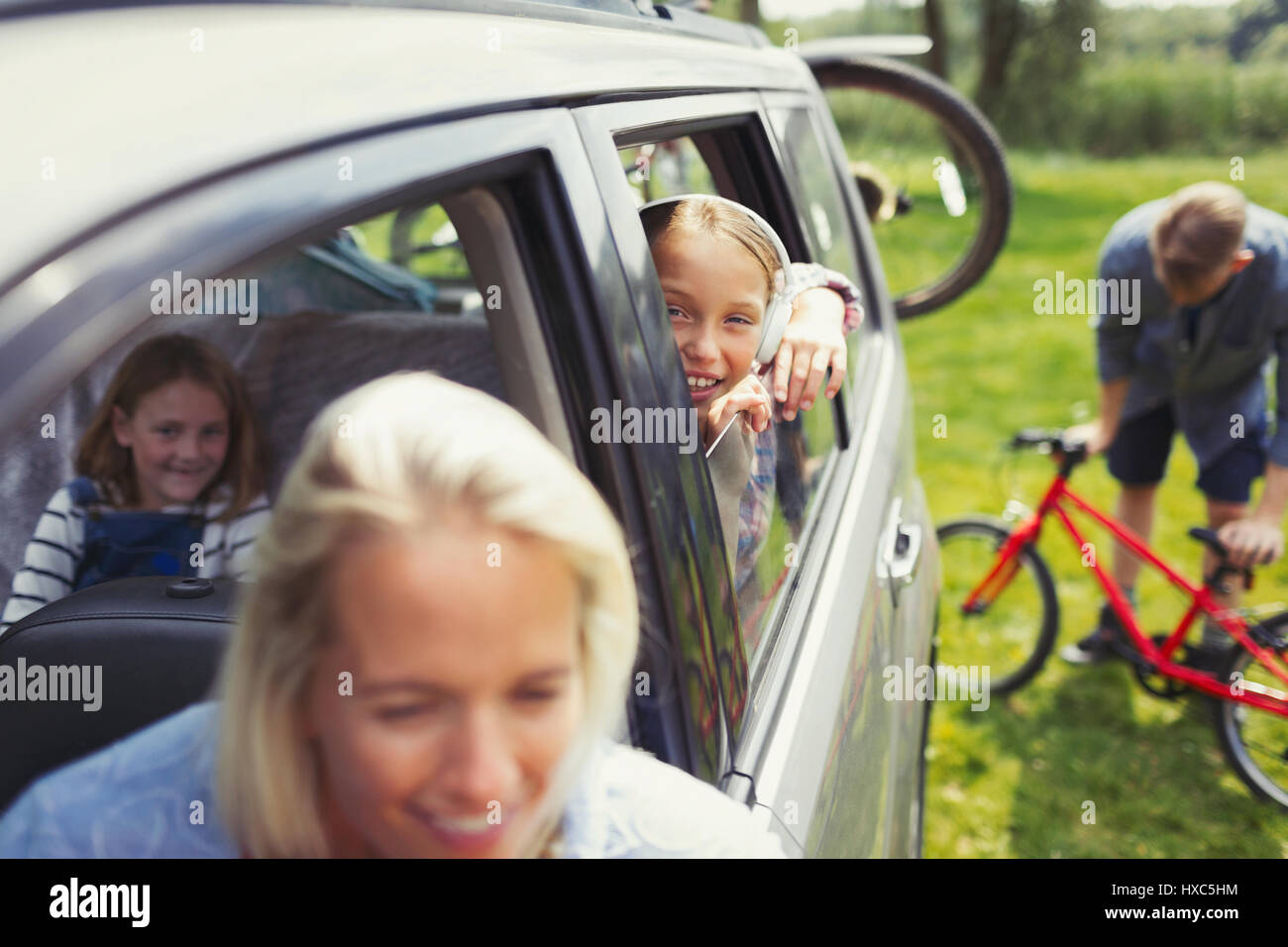 Portrait smiling girl with family inside car Stock Photo