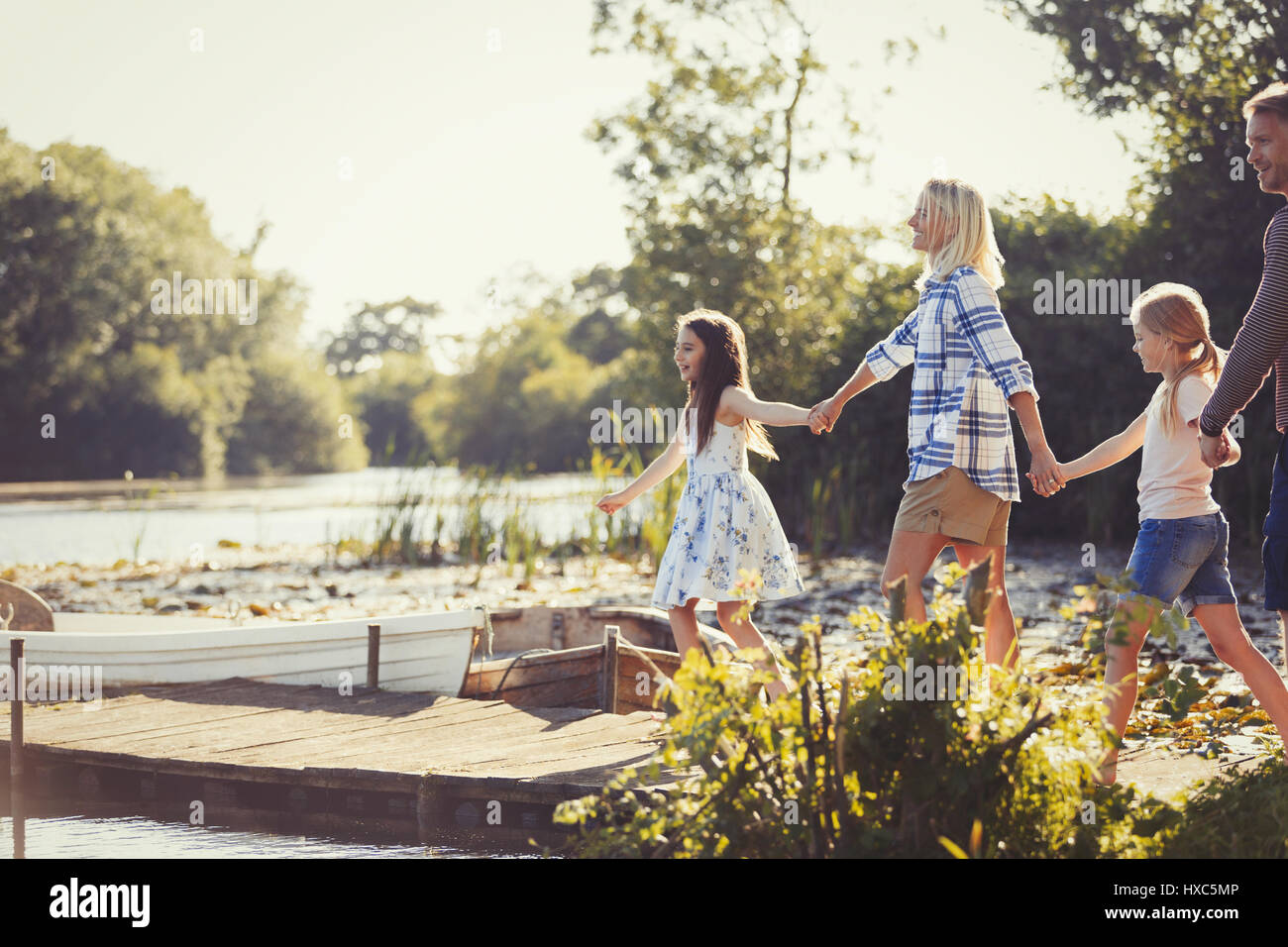 Family four hands walking lake hi-res stock photography and images - Alamy