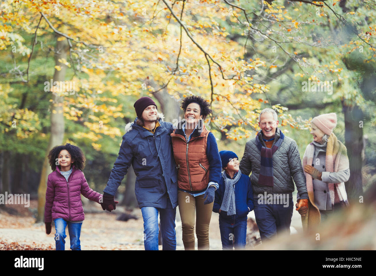 Multi-generation family walking in autumn woods Stock Photo