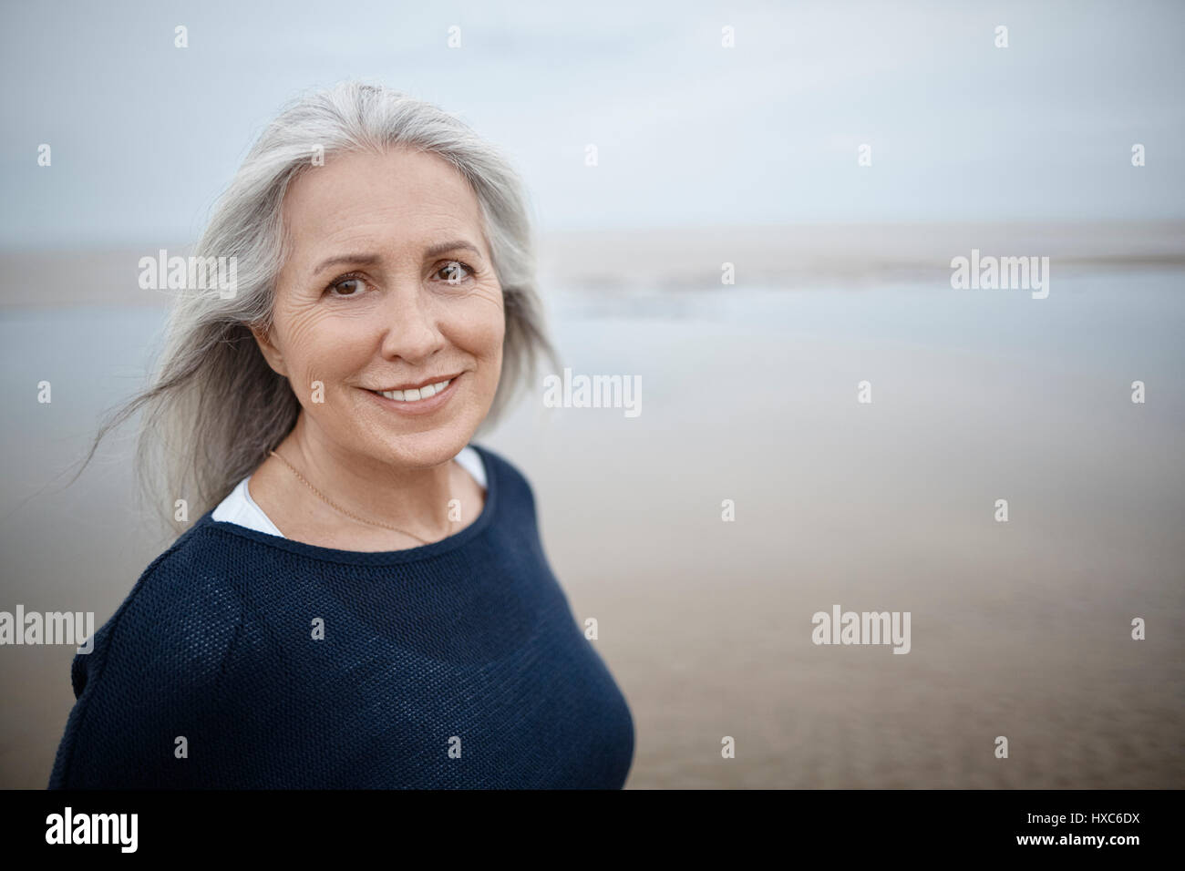 Portrait smiling senior woman on beach Stock Photo - Alamy