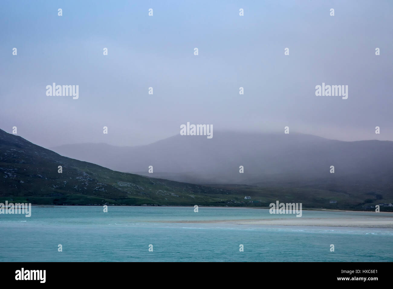 Fog rolling over tranquil mountains and ocean, Golden Road, Harris, Outer Hebrides Stock Photo