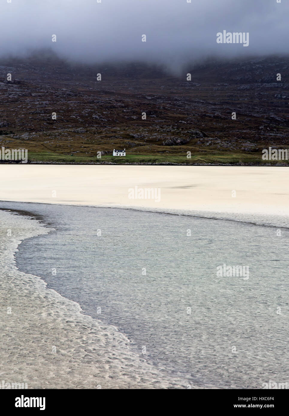 Tranquil view ocean and remote house, Luskentyre Beach, Harris, Outer Hebrides Stock Photo