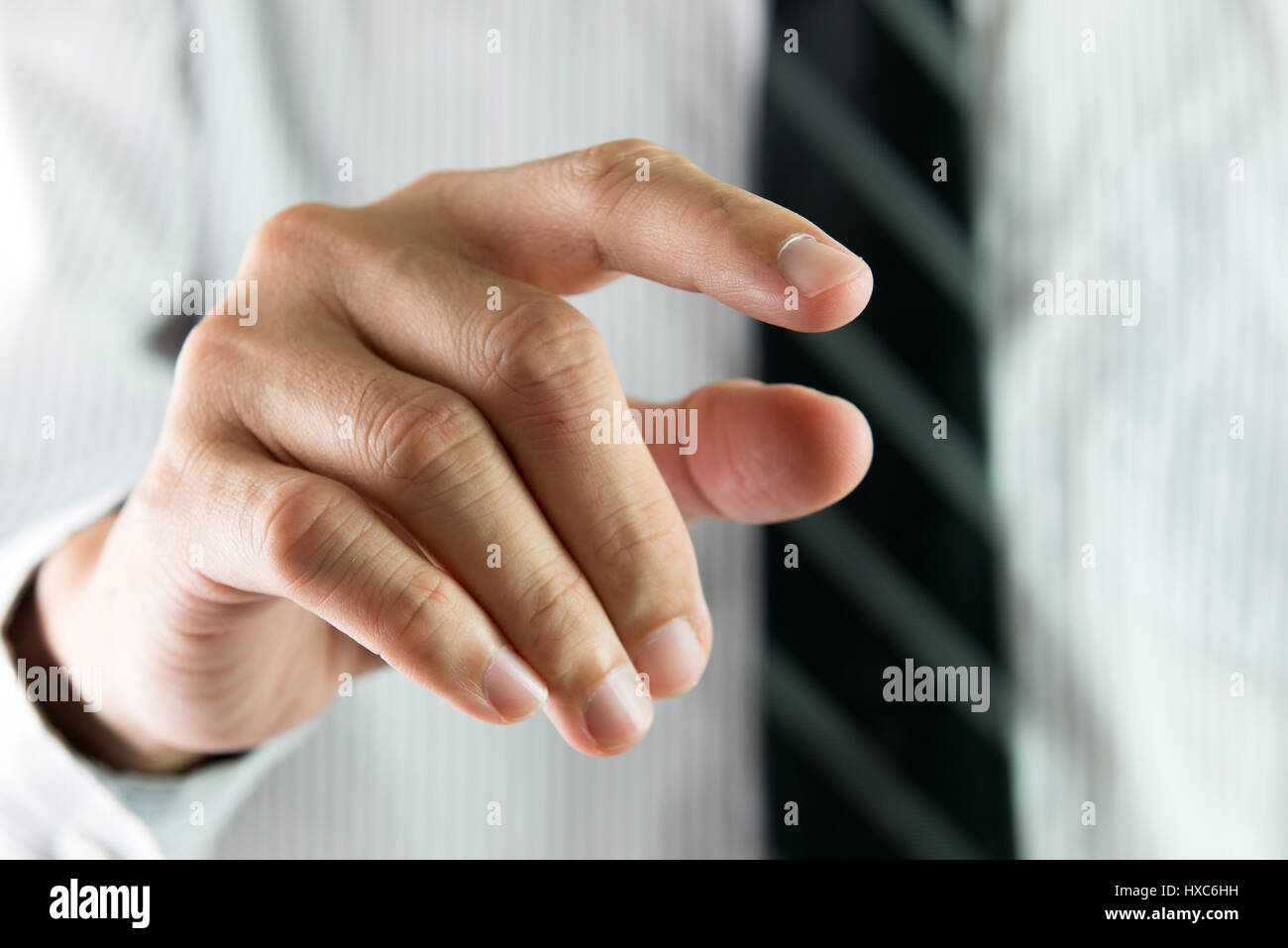 Businessman reaching out or touching virtual interface with his finger Stock Photo