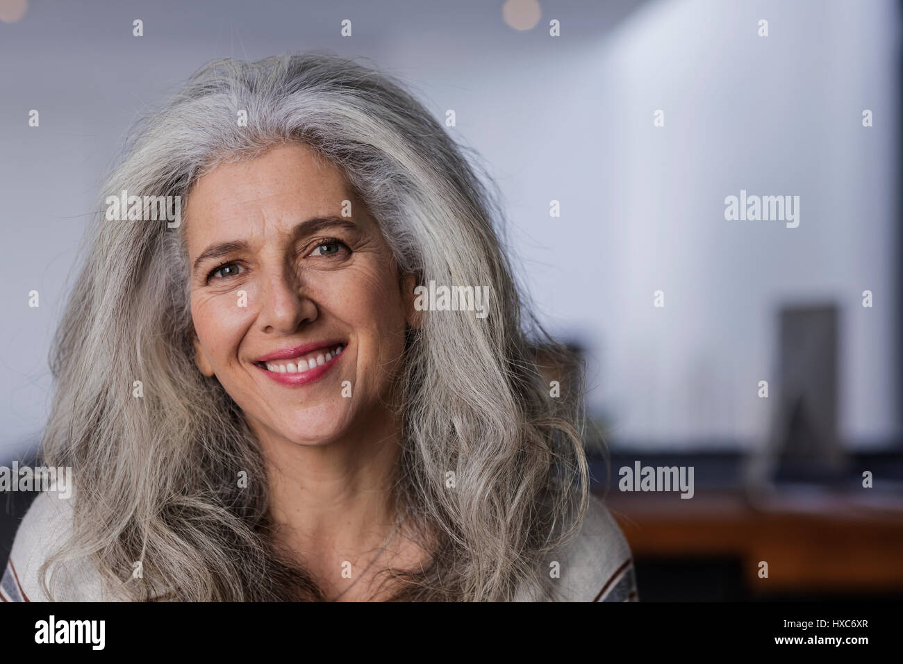 Portrait smiling mature woman with long, gray hair Stock Photo