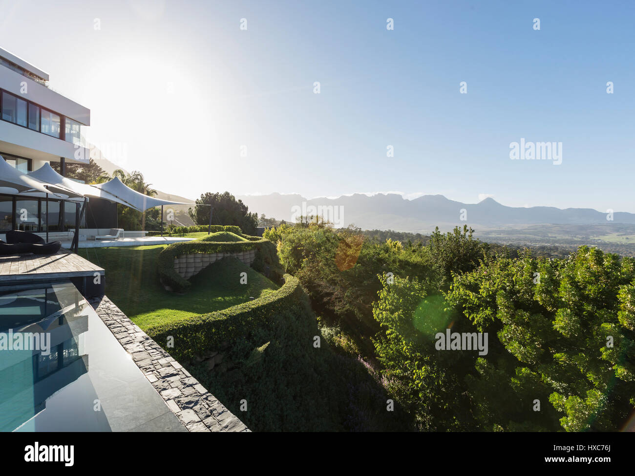 Modern luxury home showcase exterior and swimming pool with sunny ...