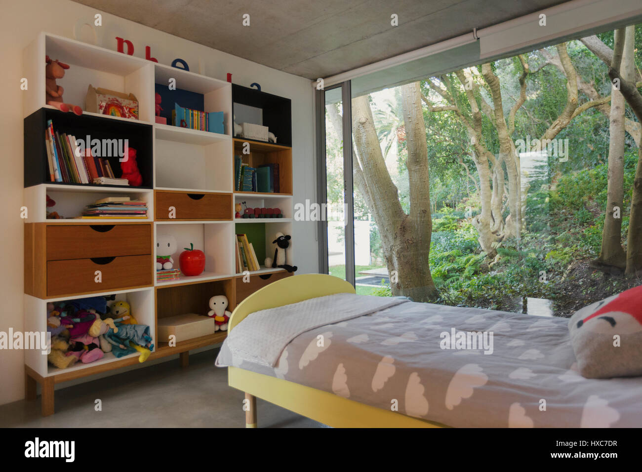 Home showcase interior child’s bedroom with view of trees in garden Stock Photo