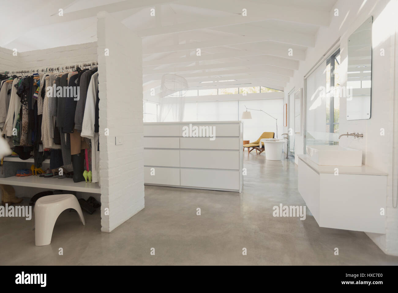 White, modern, minimalist walk-in closet and bathroom vanity Stock Photo