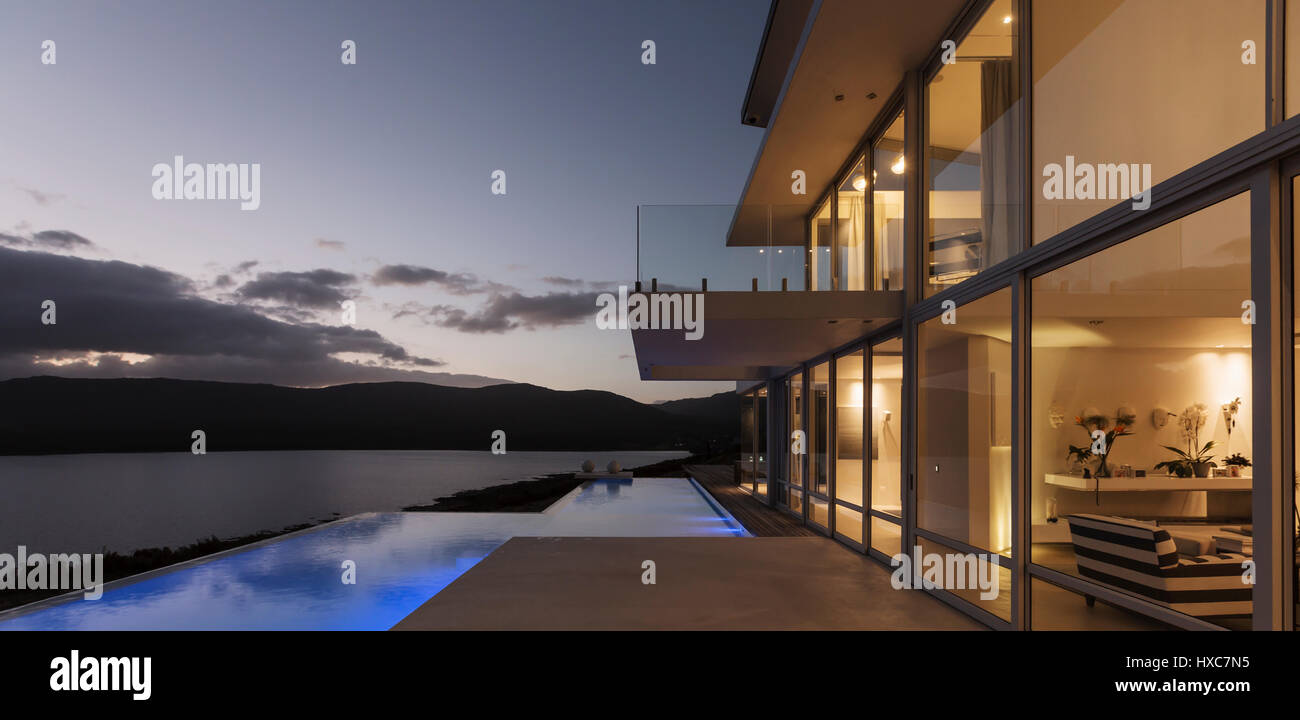Tranquil modern luxury home showcase exterior with illuminated infinity ...