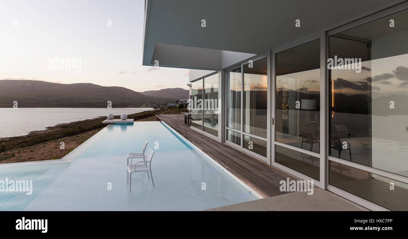 Modern luxury home showcase exterior with infinity pool and ocean view ...