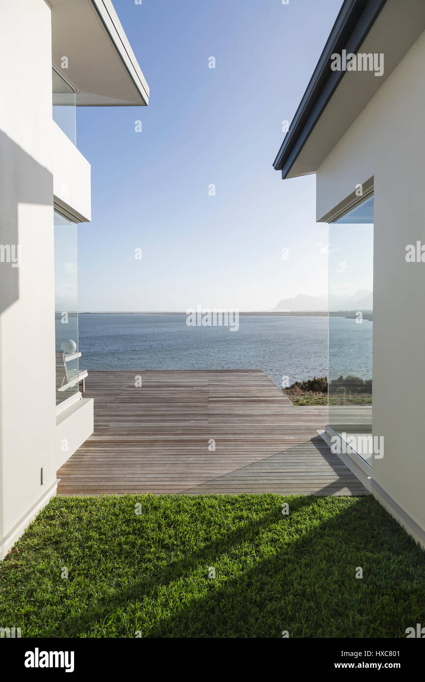 Modern home showcase exterior courtyard with sunny, tranquil ocean view ...