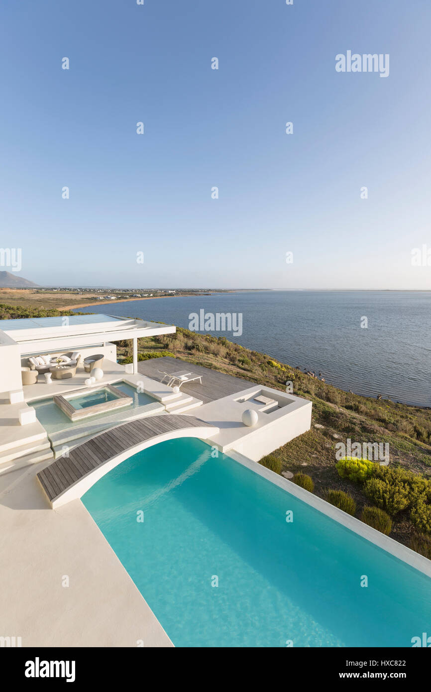 Sunny, tranquil modern luxury home showcase infinity pool with ...