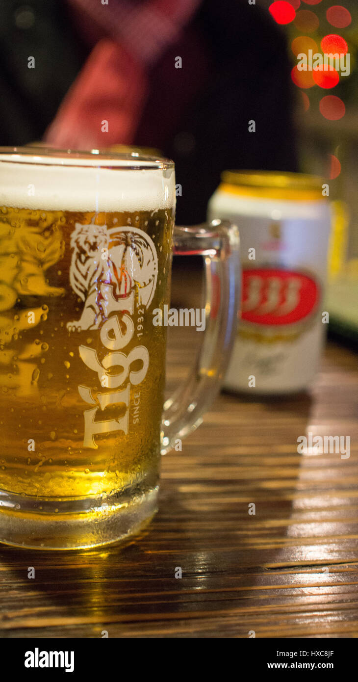 Closeup of a Mug of Thai Tiger Beer with Beer Can in Background in Bangkok Stock Photo