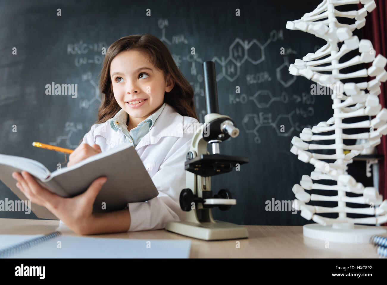Inspired little researcher studying science in the laboratory Stock Photo