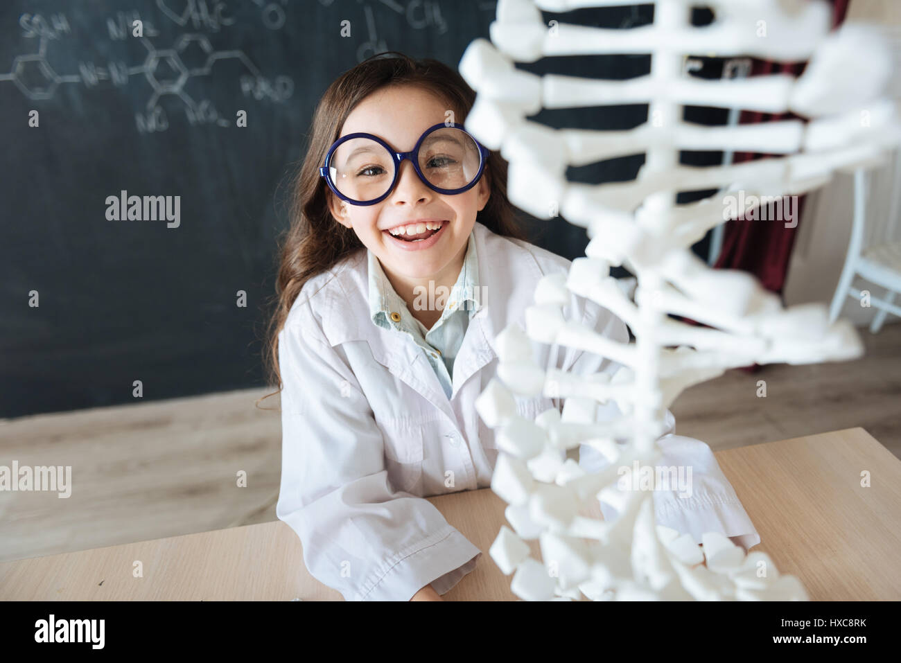 Charismatic young scientist exploring DNA model in the laboratory Stock ...