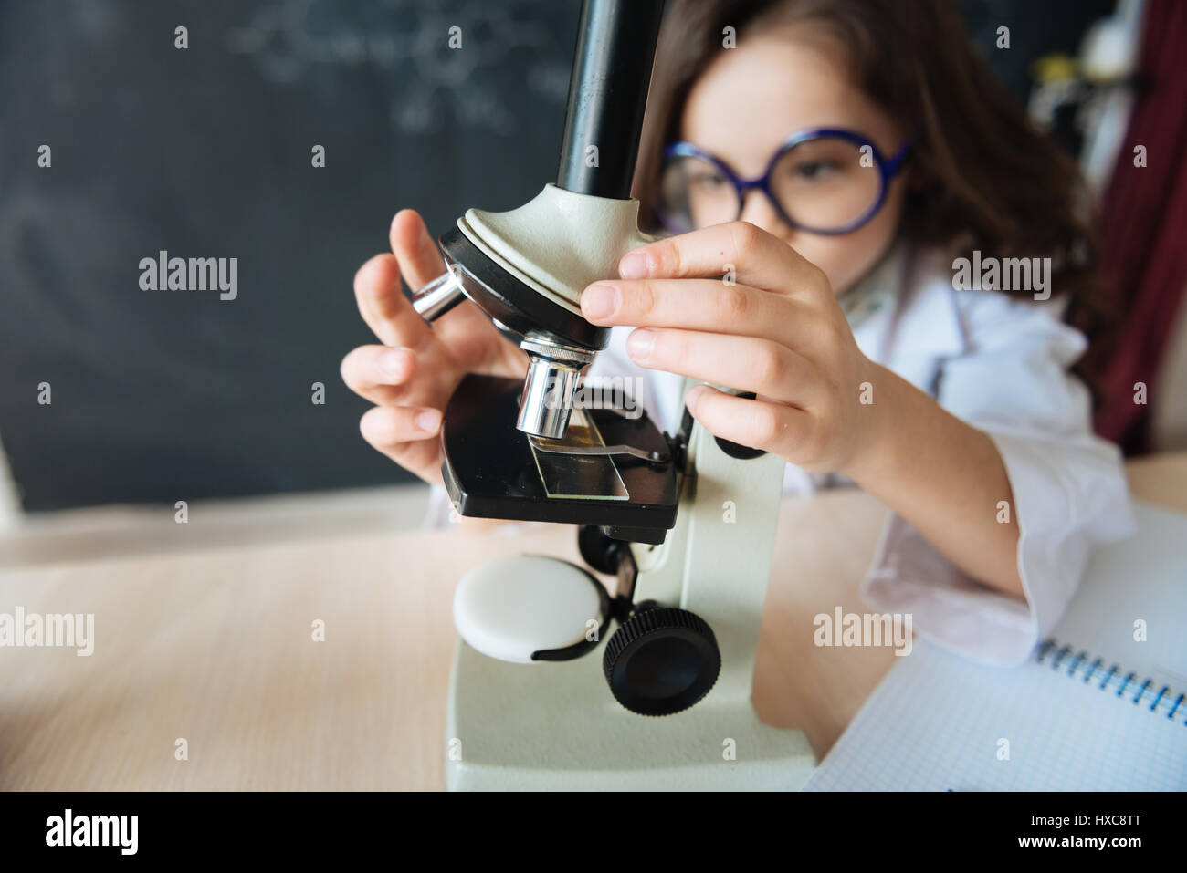 Responsible little girl using science equipment in the laboratory Stock ...