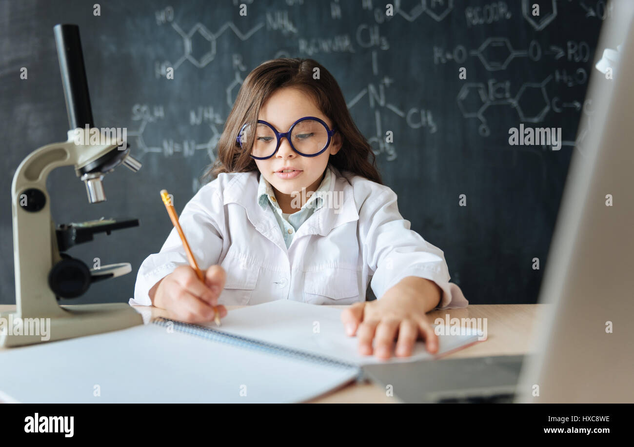 Involved little scientist studying in the laboratory Stock Photo