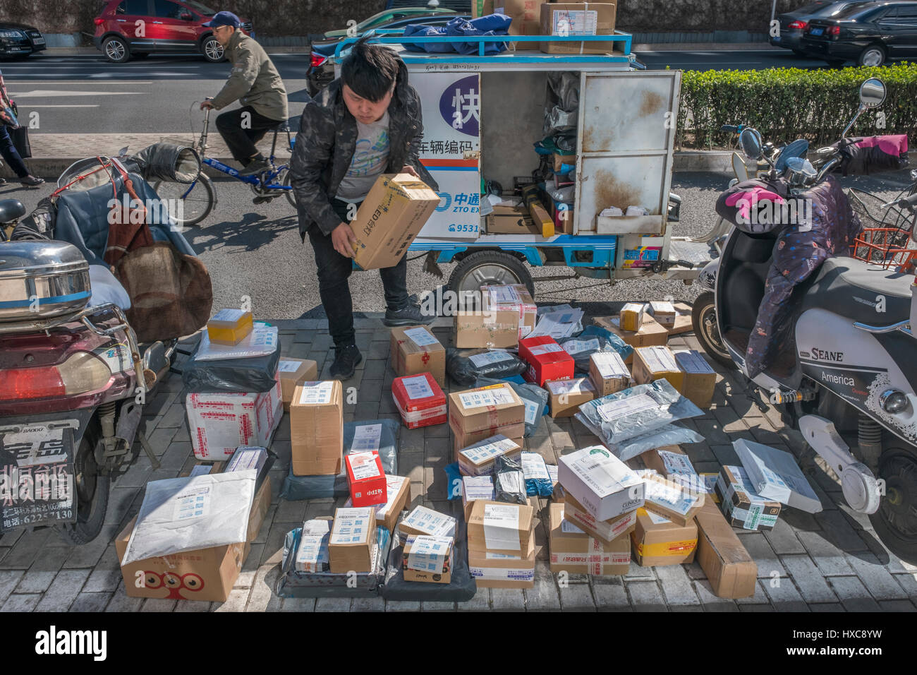 An express courier stacks parcels by the roadside in Beijing, China. 27-Mar-2017 Stock Photo