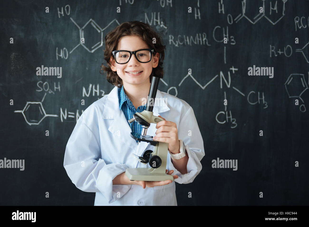 Positive Researcher Positive little researcher using modern technologies in the laboratory ...