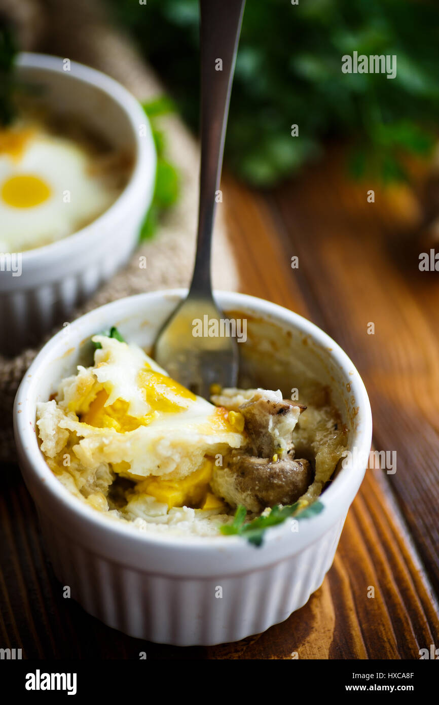 Baked egg with minced fish and mushrooms Stock Photo
