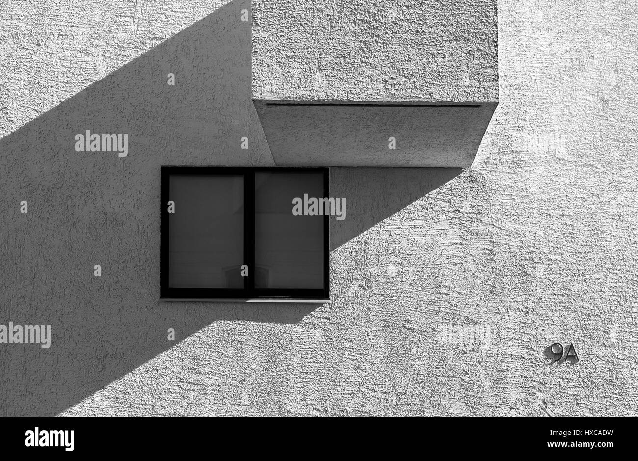 High contrast black and white picture of modern abstract looking building with window and balcony detail Stock Photo