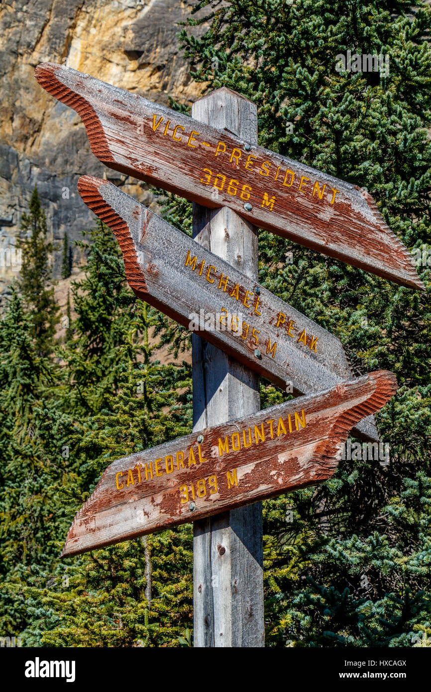 A finger signpost at Takakkaw Falls in Yoho National Park, British Columbia, Canada. Showing close mountains ranges and heights. Stock Photo