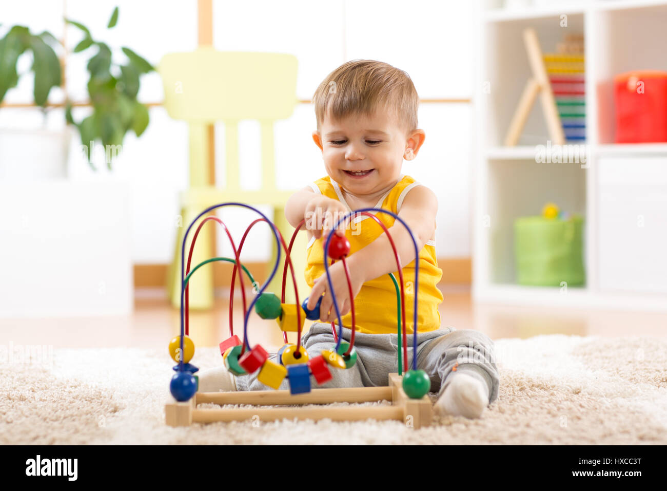 kid boy plays with educational toy indoors Stock Photo