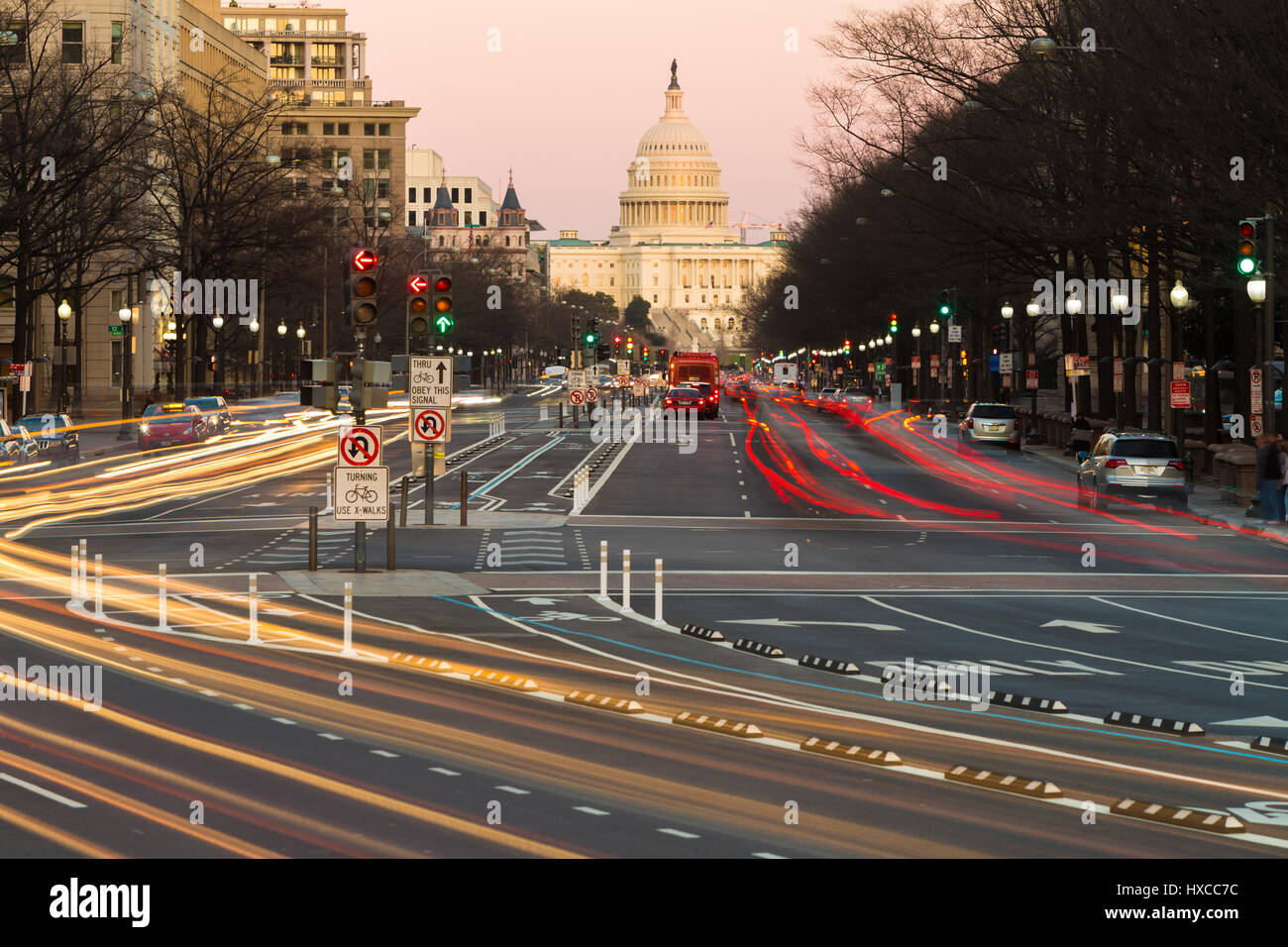 Traffic creates light trails and motion blurs leading to the US Capitol Building on Pennsylvania Avenue in Washington, DC. Stock Photo