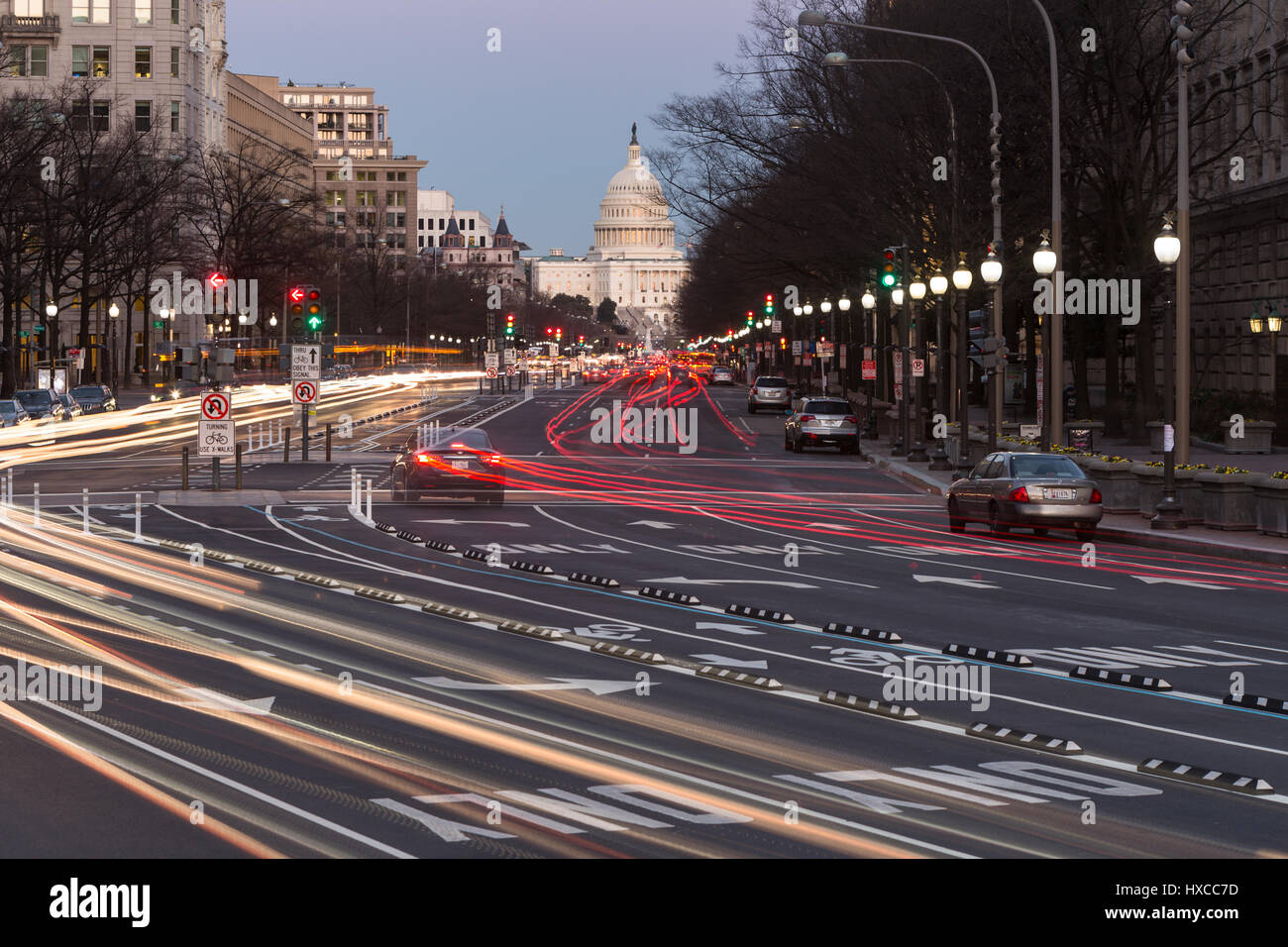 Traffic creates light trails and motion blurs leading to the US Capitol Building on Pennsylvania Avenue in Washington, DC. Stock Photo