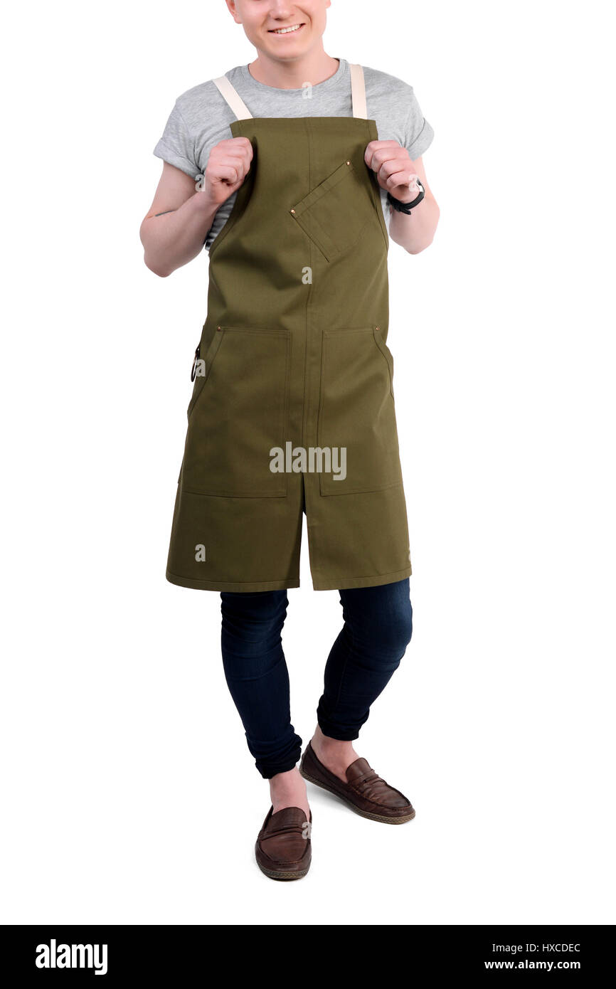 Young man chef, waiter or bartender posing, wearing apron and tshirt isolated on white