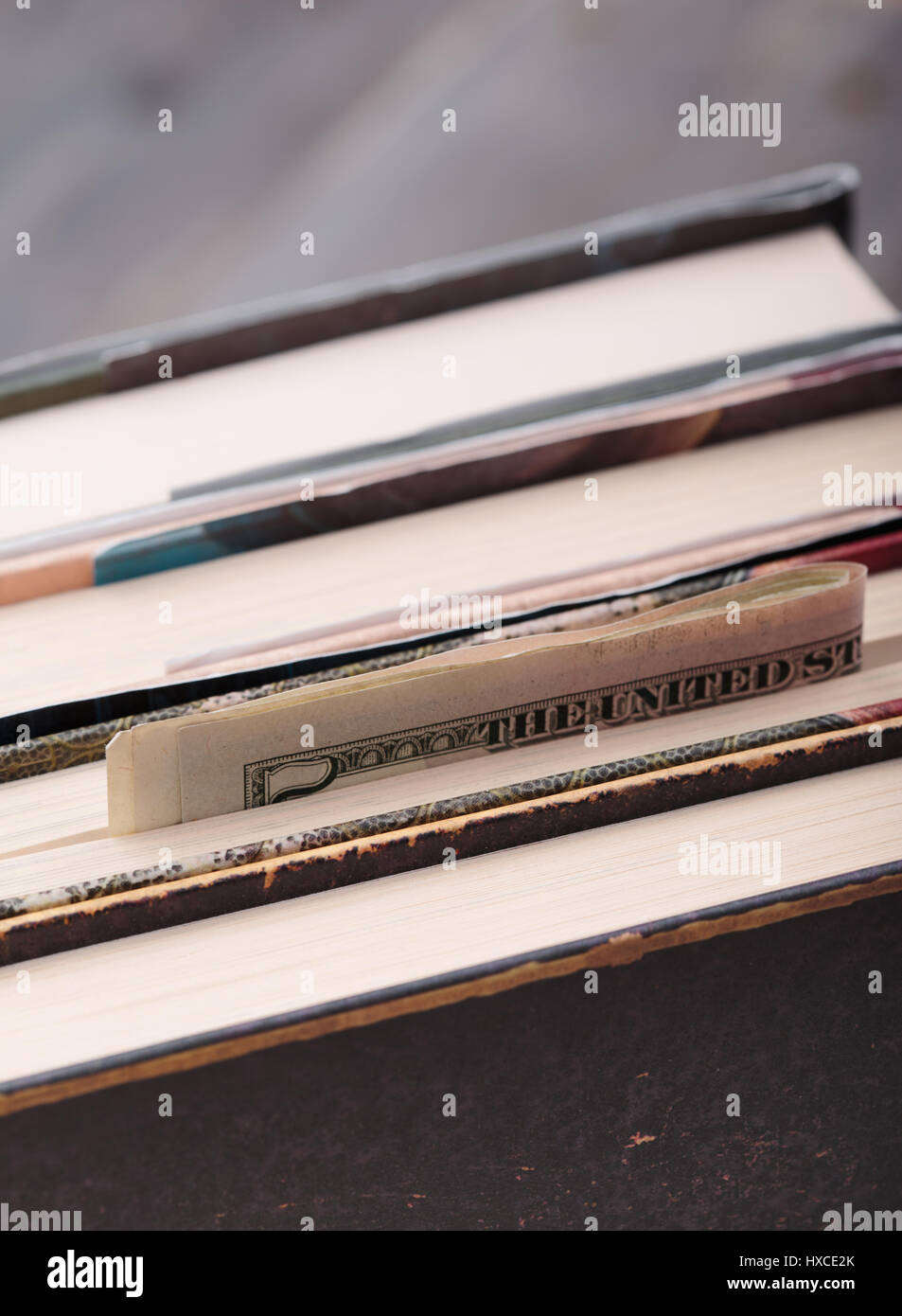 Folded banknotes hidden in books Stock Photo - Alamy