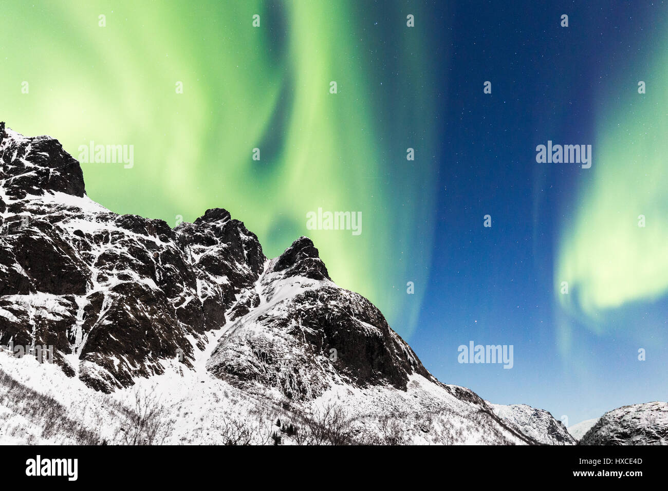 Lofoten, Svoelver, Aurora Borealis over a frozen lake, Norway. Stock Photo