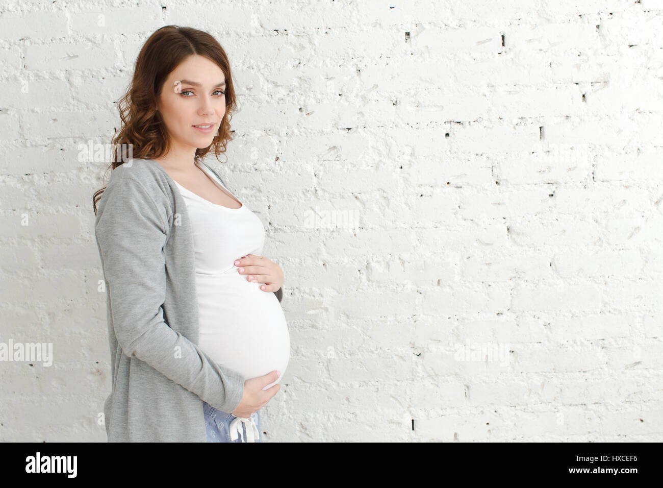 Pregnant female posing looking at camera Stock Photo