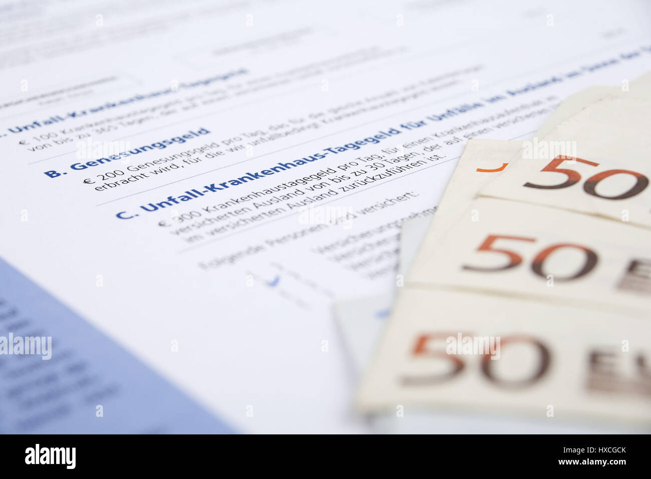 Insurance policy of an accident insurance with bank notes, Insurance policy of accident insurance with bank notes |, Versicherungsschein einer Unfallv Stock Photo