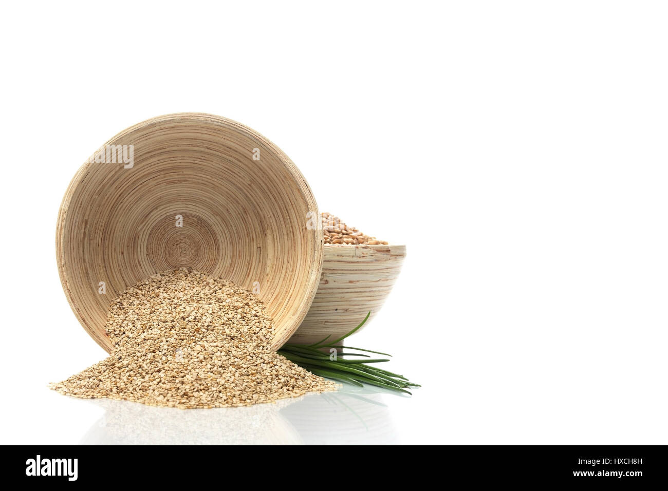 Wooden bowls with sesame punch, Holzschalen mit Sesamkoerner Stock Photo