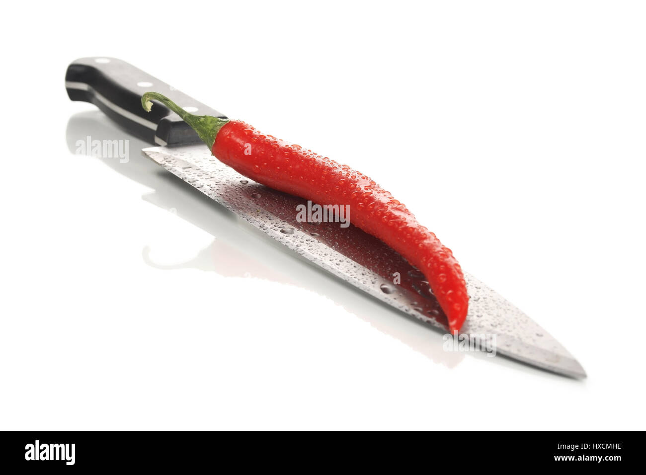 Culinary knife with a chilli, Kitchen knife with a red pepper |, Küchenmesser mit einer Peperoni |Kitchen knife with a red pepper| Stock Photo