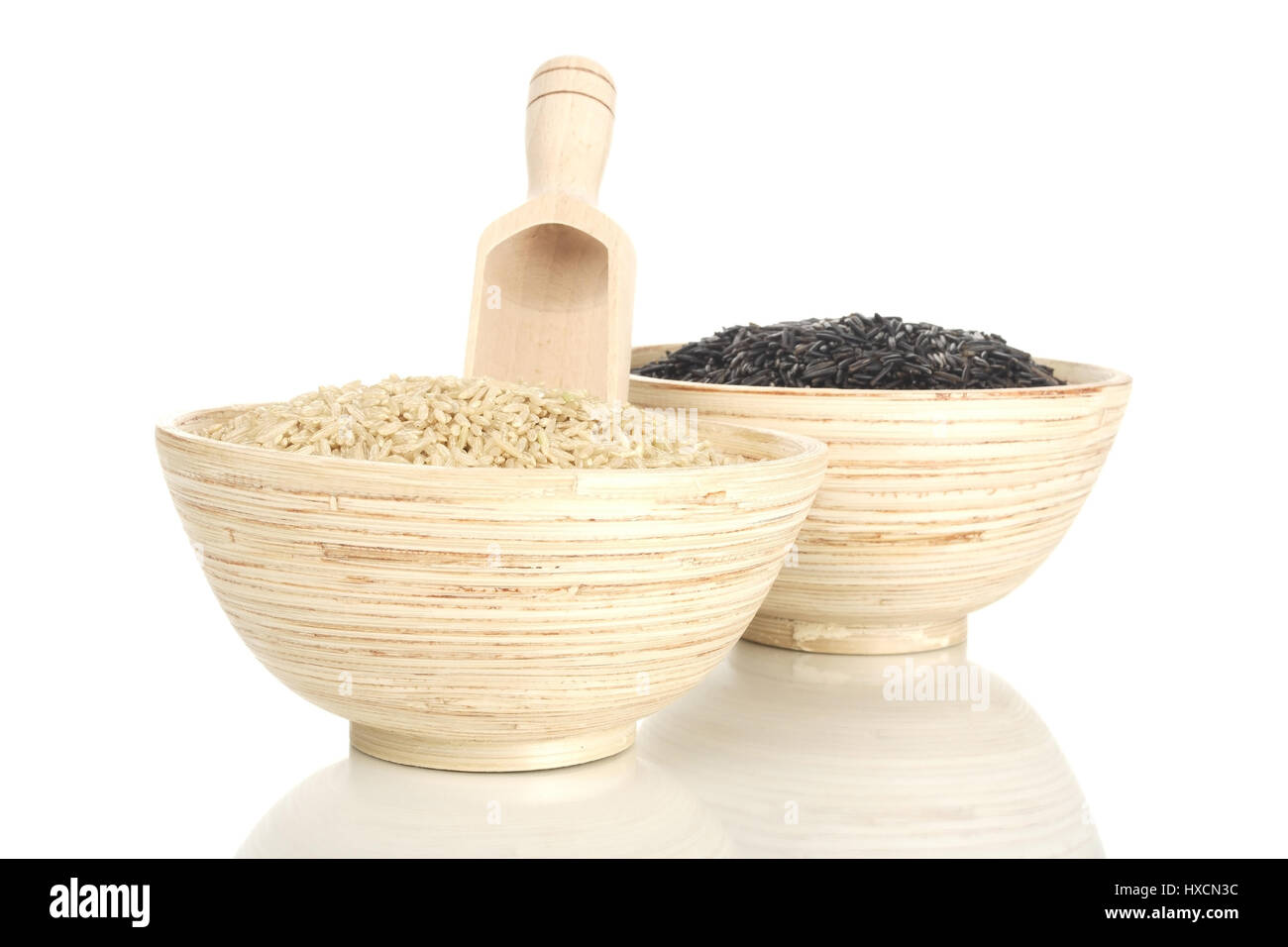 Wooden bowls with natural rice and wild rice, Holzschalen mit Natur- und Wildreis Stock Photo
