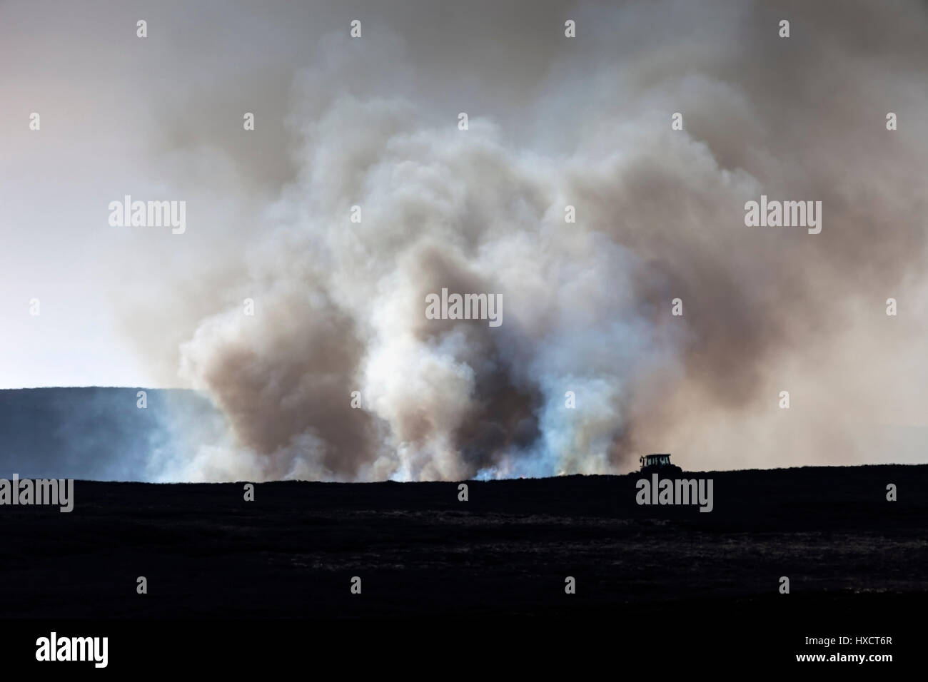 North Pennines, County Durham UK. Sunday 26th March. UK Weather.  A landscape distorted by heat haze and smoke as the annual controlled heather burning of the grouse moors continues during the warm spring weather in the North Pennines © David Forster/Alamy Live News. Stock Photo