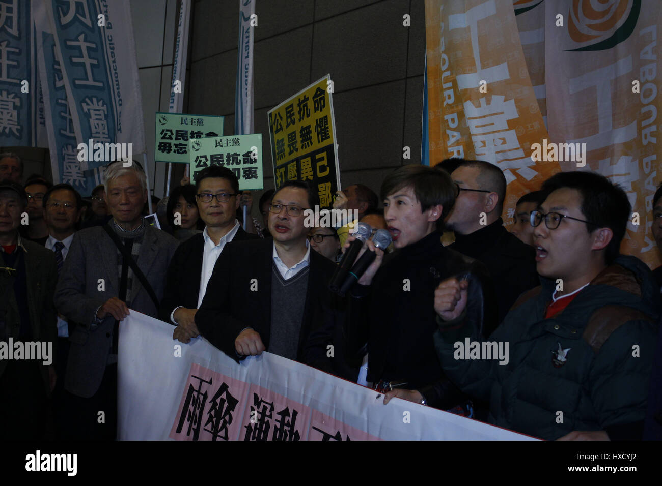 March 27, 2017 - 9 members, including 3 person who played key role in 2014 UMBRELLA MOVEMENT-Occupation Central, Reverend Chiu Yiu-ming ( L ), academic, Chan Kin-man ( Second from left ) and Benny Tai ( third from left ) are today charged with 3 accounts of crime which include citing social unrest etc. All 9 accused demonstrated outside Hong Kong Police Headquarter in the evening surrounded by hundred of supporters. 2017, 3-27. Hong Kong. ZUMA/Liau Chung Ren Credit: Liau Chung Ren/ZUMA Wire/Alamy Live News Stock Photo
