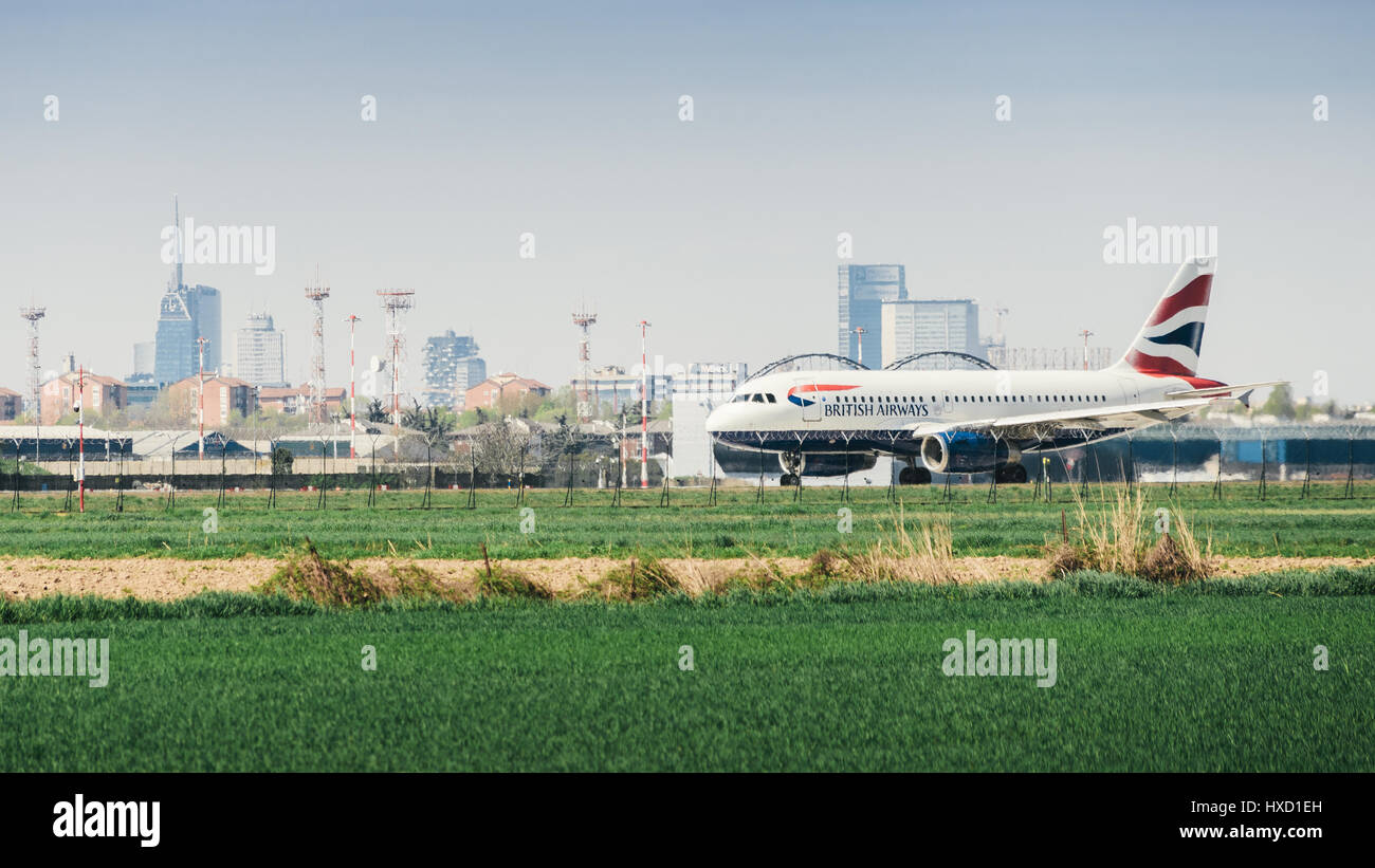A British Airways commercial airplane takes off from Milan's Linate ...