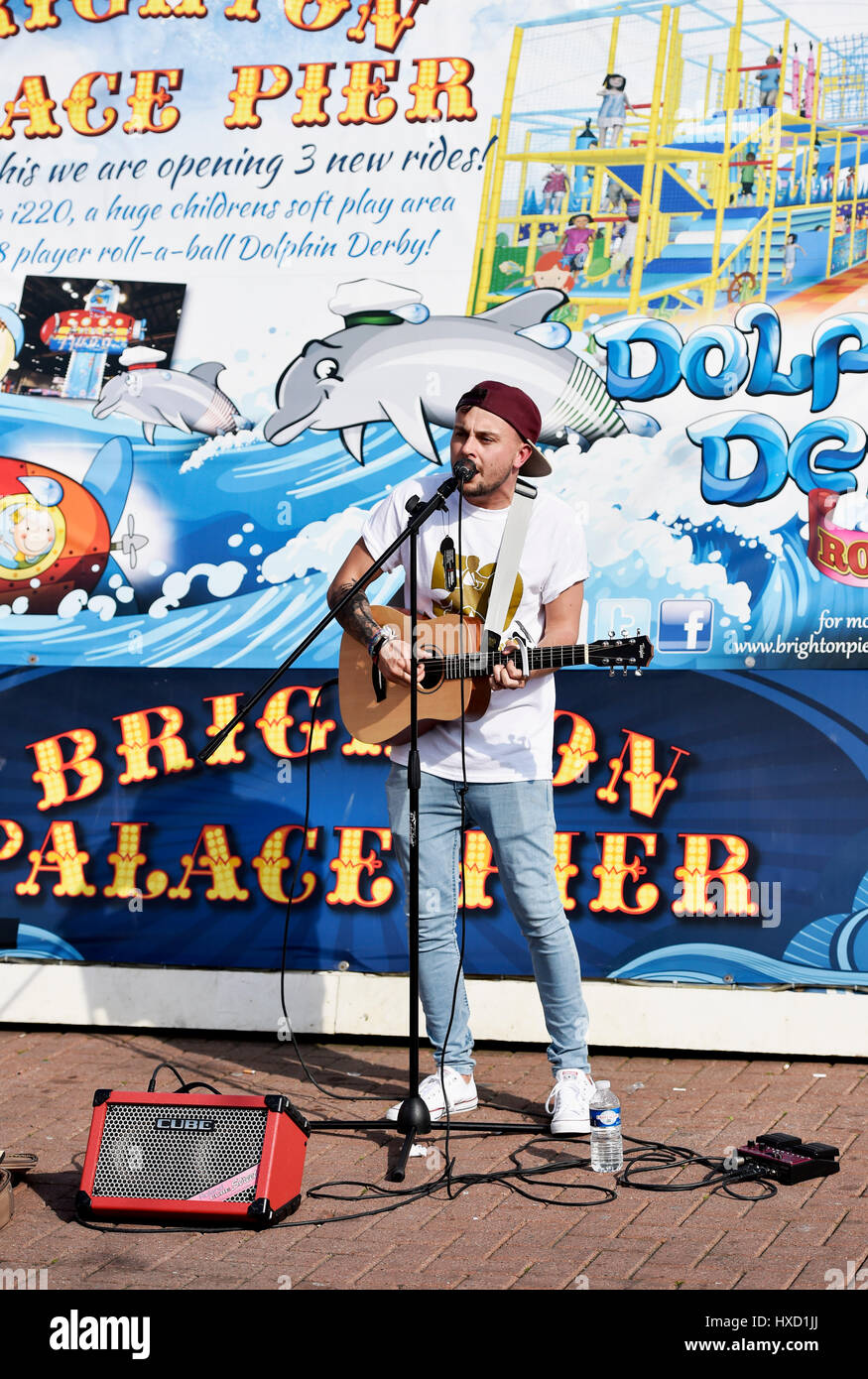 Brighton, UK. 27th Mar, 2017. A musician entertains the crowds by the Palace Pier Brighton as the hot Spring weather continues throughout Britain today Credit: Simon Dack/Alamy Live News Stock Photo